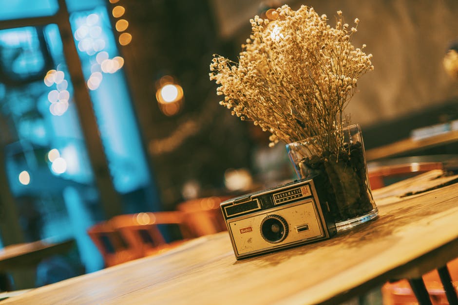 cafe table with a radio and dry flowers